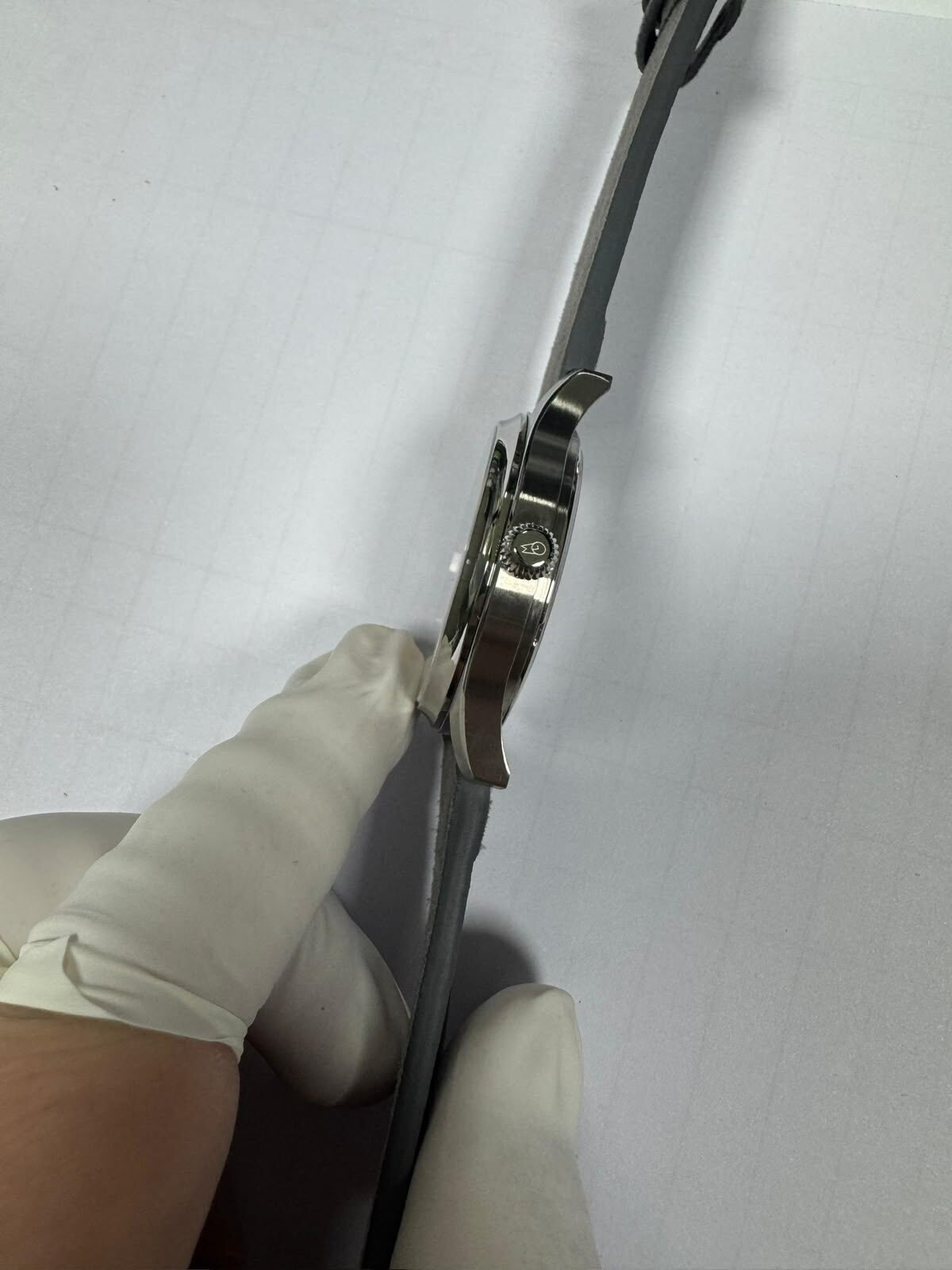 Gloved hands fitting the strap to the case