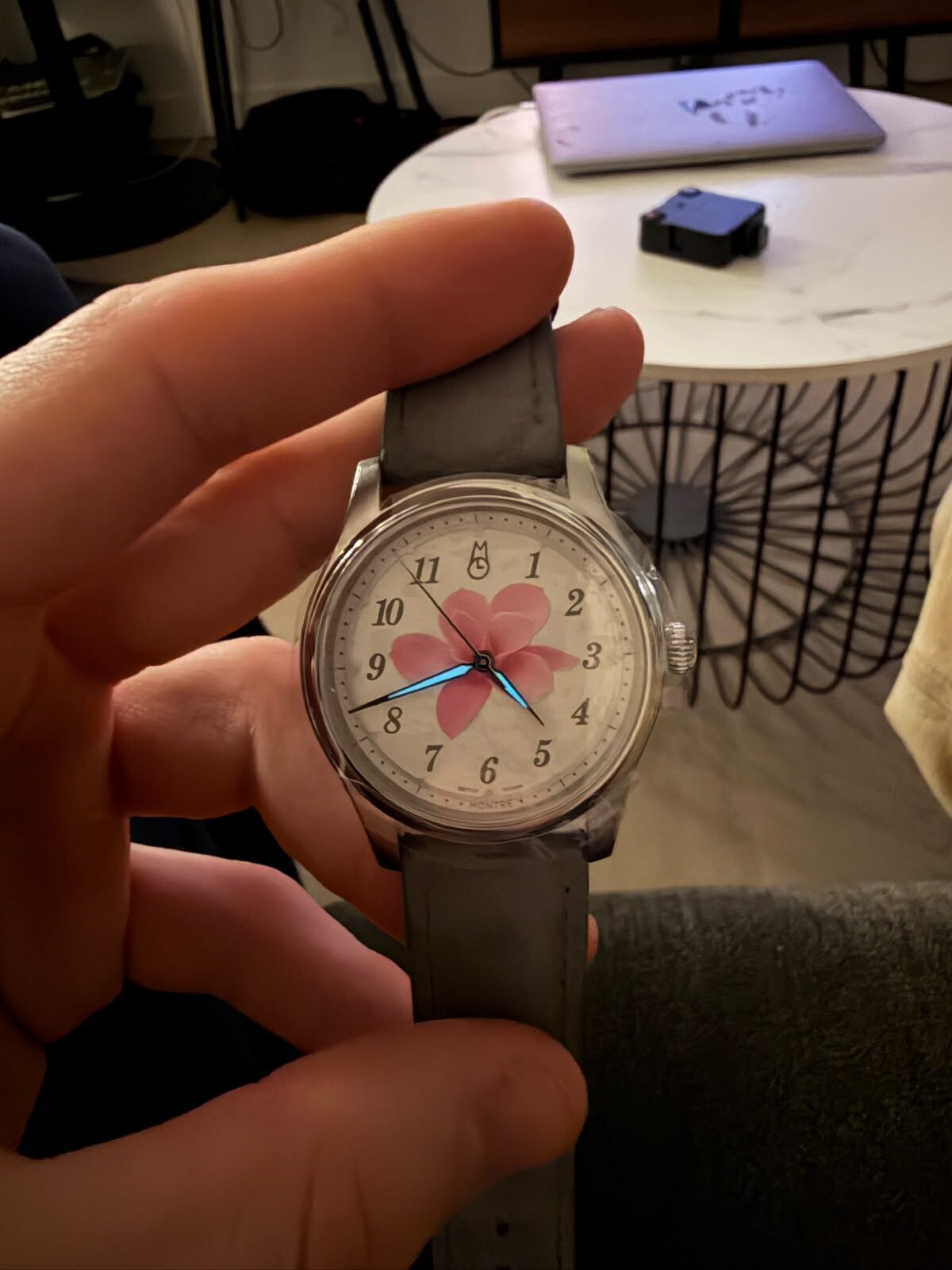 The finished watch held in a hand