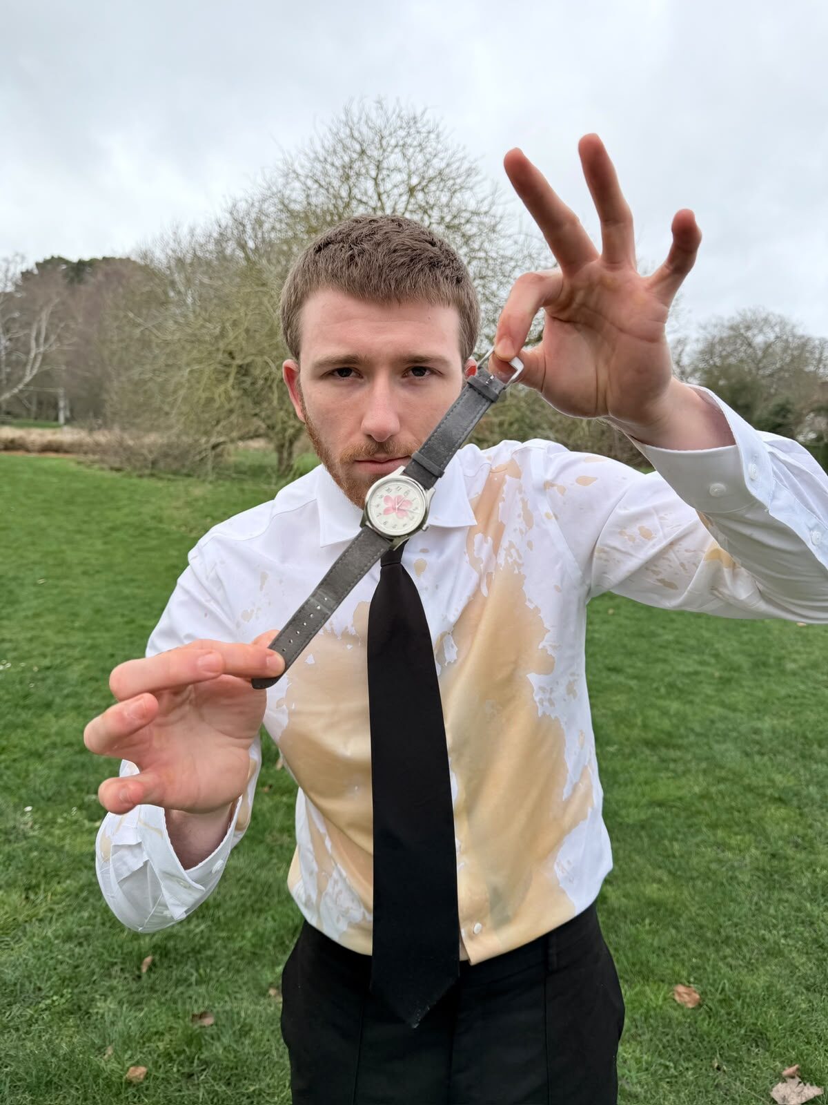 The founder outdoors, holding the watch